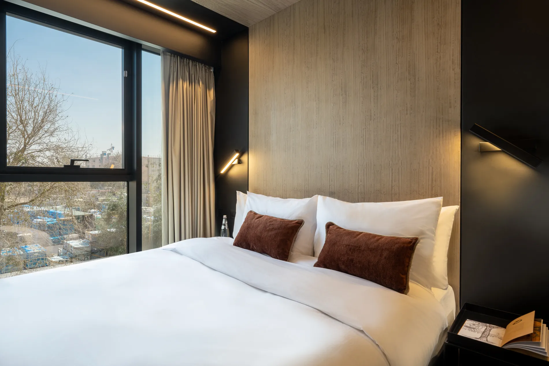 Comfortable bedroom in the One-Bedroom Suite with Sofa Bed at master Bat Yam, featuring a plush bed and a warm, inviting atmosphere.