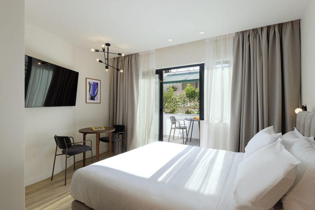 Relaxing bedroom area in the Studio with Balcony at master Plaka Athens, seamlessly connecting to a private outdoor retreat.