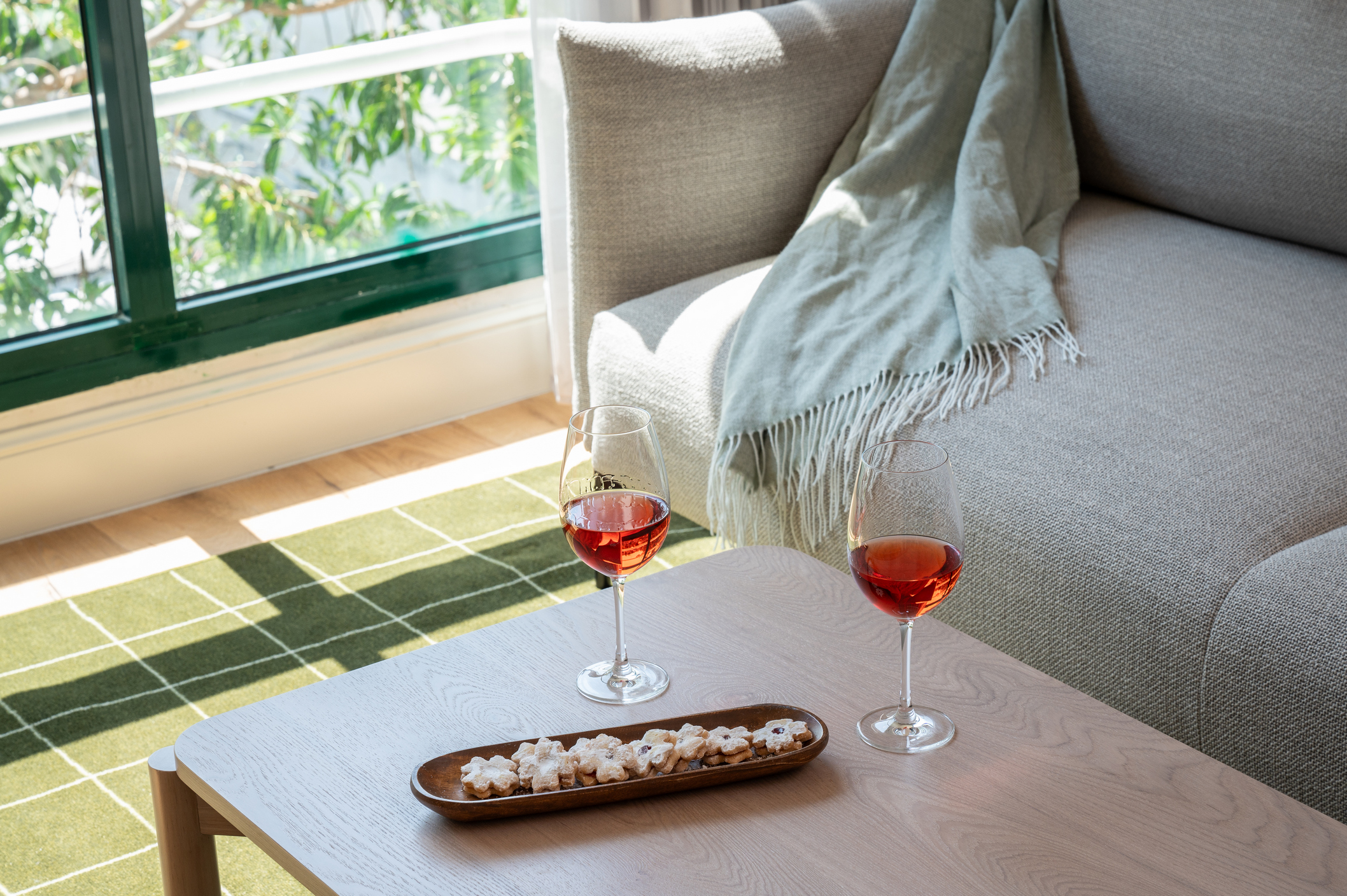 Sophisticated ambiance in the One-Bedroom with Big Terrace & Sofa Bed at master Mazeh Tel Aviv, showcasing a table set with champagne and glasses for a special occasion