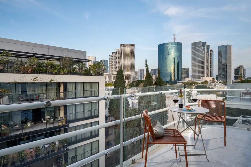 Well-appointed balcony in the One-Bedroom with Balcony at master Mazeh Tel Aviv, seamlessly extending the living space to the outdoors.