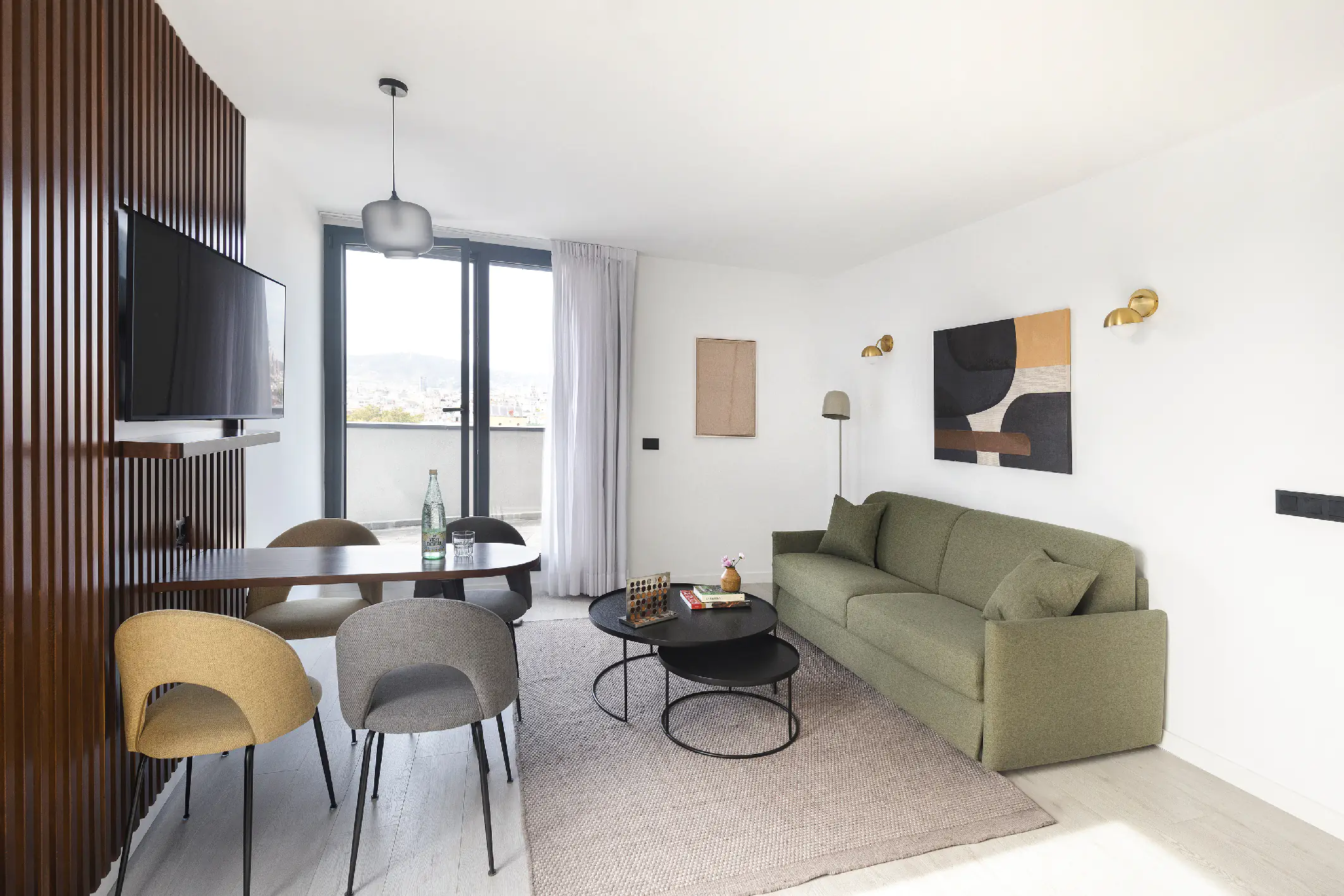 Contemporary penthouse living room with green sofa, wood accents, and full kitchen, opening onto a private terrace.